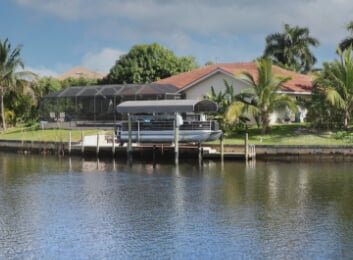 a boat on a doc behind home on the water