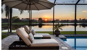 pool with two chairs overlooking a lake in florida