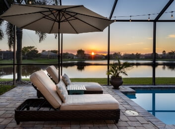 pool with two chairs overlooking a florida lake